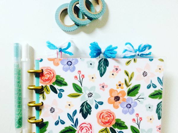 Three pom pom bookmarks in planner