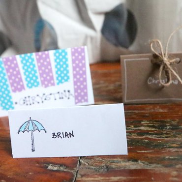 Set of 3 decorated DIY place cards with hand lettered names, washi, and rope