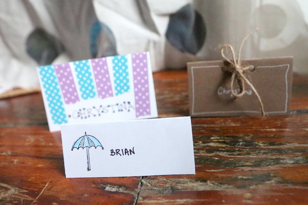 Set of 3 decorated DIY place cards with hand lettered names, washi, and rope