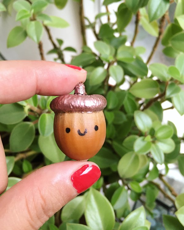 Painted acorn with smiley face close up