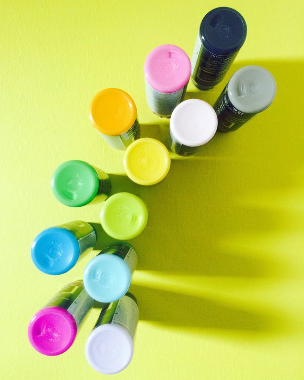 Rainbow of acrylic paint bottles