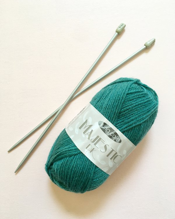 Teal wool and knitting needles